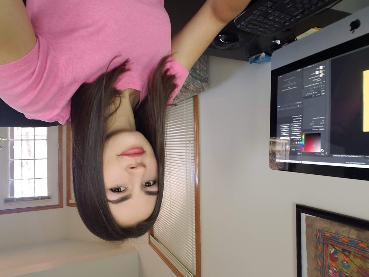 Lilly at her desk designing animations in Photoshop