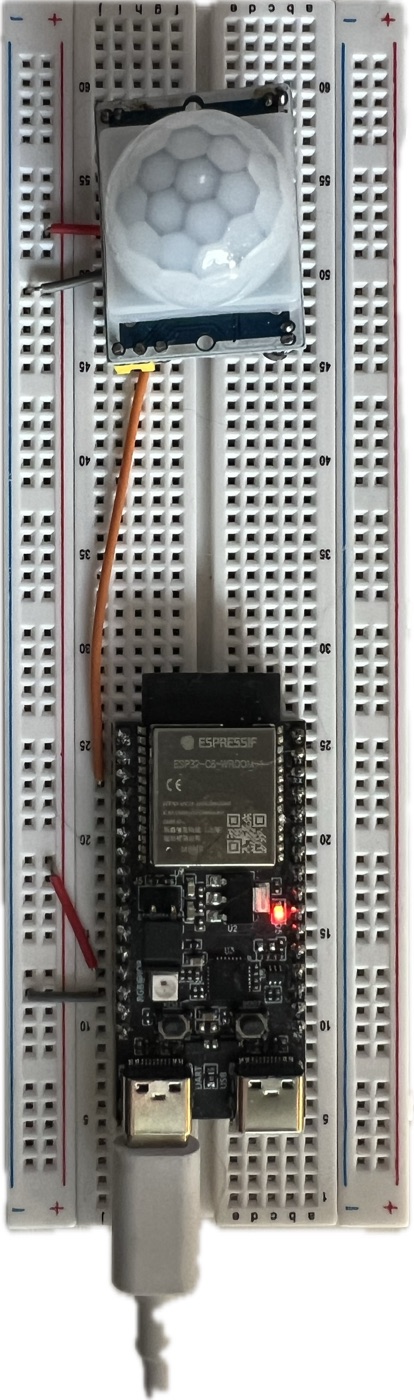 Close-up of the motion sensor wired to the ESP32-C6 on a breadboard