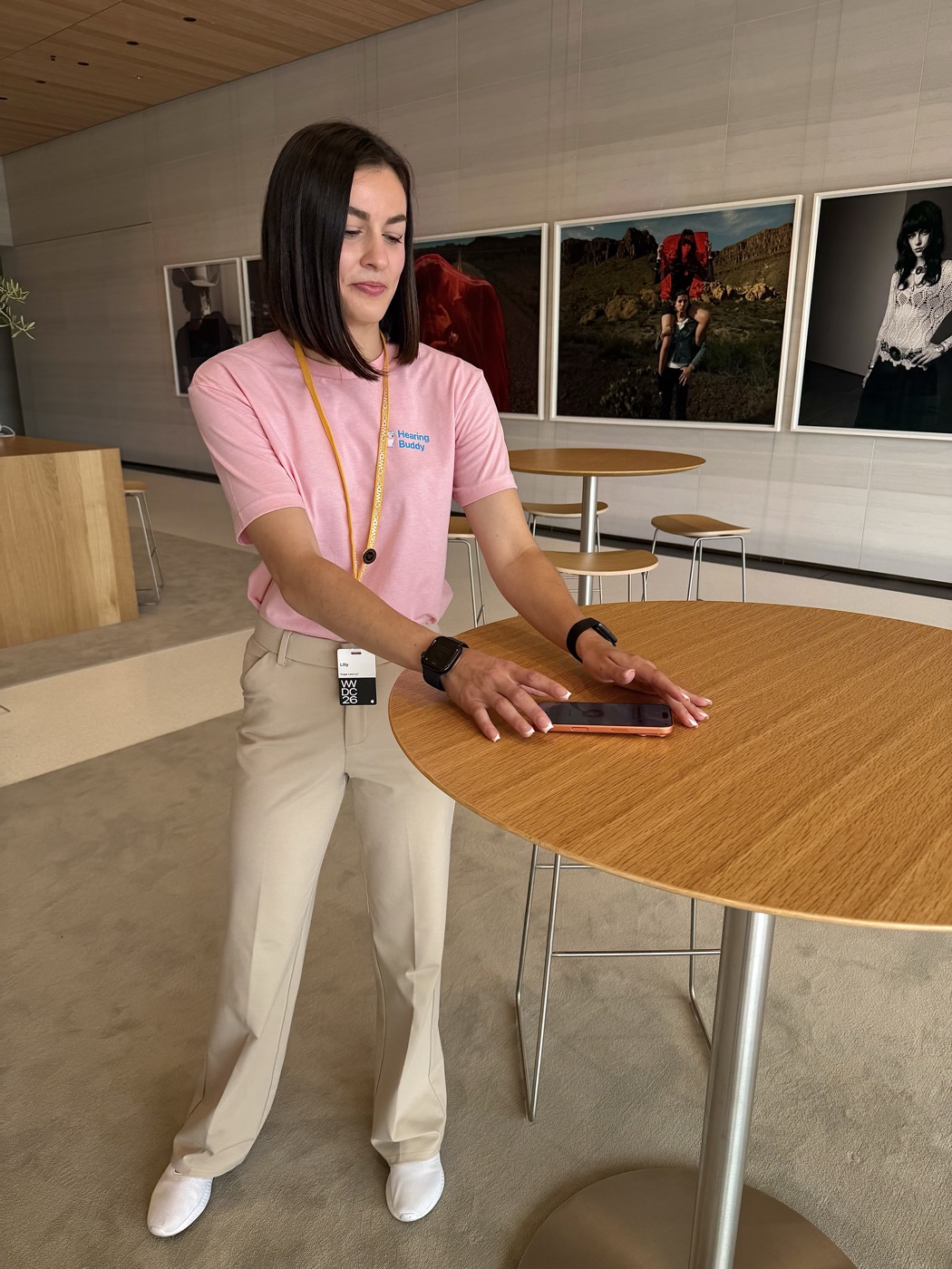 Lilly at a table with her phone between demos
